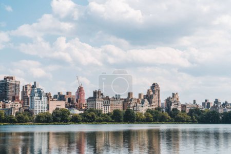 Photo for New York upper east side under light sky, waterfront and green park. Office buildings in Manhattan, skyscrapers skyline, business company - Royalty Free Image