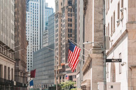 Foto de New York wall street, stock exchange building and american flags in row. Concept of money and international banking system - Imagen libre de derechos