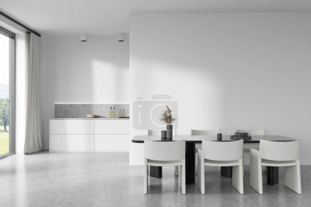 Téléchargez les photos : Front view on bright kitchen room interior with empty white wall, dining table with armchairs, panoramic window, cupboard, concrete floor, gas cooker. Concept of minimalist design. 3d rendering - en image libre de droit