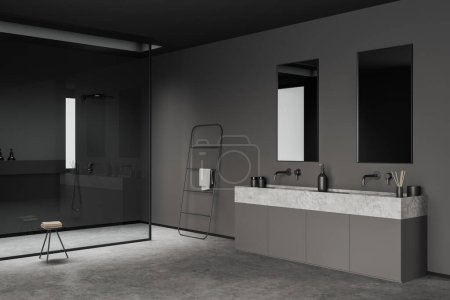 Téléchargez les photos : Dark bathroom interior with sink, shower and table with towel on grey concrete floor. Towel rail ladder in modern hotel studio, side view. 3D rendering - en image libre de droit