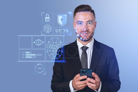 Téléchargez les photos : Glad handsome businessman in formal suit holding smartphone with facial recognition digital interface. Concept of innovative technology created to help business people to protect their business - en image libre de droit