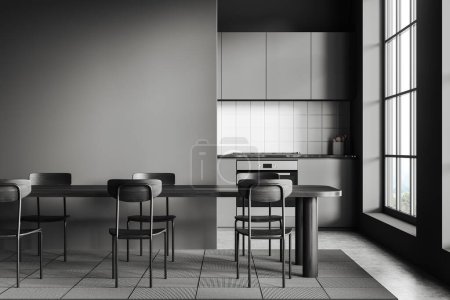 Téléchargez les photos : Dark kitchen interior with dinner table and mock up empty partition. Cooking area with shelves on background, grey concrete floor. Panoramic window on countryside. 3D rendering - en image libre de droit