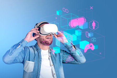 Téléchargez les photos : Businessman wearing casual wear and vr googles watching metaverse reality with sketch hologram of gamepad, headset. Concept of futuristic technology, virtual reality and progressive people in business - en image libre de droit