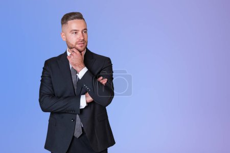 Photo for Dreaming handsome businessman in formal wear touches his chin with hand near empty purple gradient wall. Concept of ambitious business person, chief, director, knowledge, thinking - Royalty Free Image