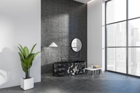 Photo for Grey bathroom interior with bathtub, table with accessories, side view, plant on grey concrete floor. Hotel studio with panoramic window on Singapore city view. 3D rendering - Royalty Free Image