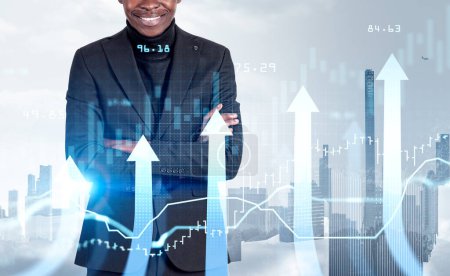 Photo for African businessman smiling with arms crossed, confident look. Growing arrows, bar chart and candlesticks, New York skyline on background. Concept of career development - Royalty Free Image