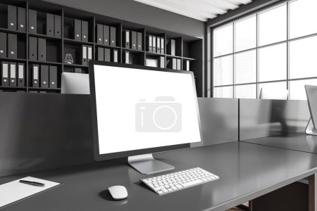 Photo for Dark workplace interior with pc computer, side view, desk and shelf with documents. Panoramic window on city view. Mockup blank screen. 3D rendering - Royalty Free Image