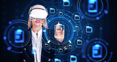 Foto de Businesswoman in vr glasses, finger touching document management system in cyberspace. Concept of online database and electronic documents - Imagen libre de derechos