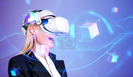 Photo for Glad businesswoman wearing vr headset watching at metaverse reality. Blockchain metaverse reality. Concept of modern technology and progress in business, entertainment, contemporary cryptocurrency - Royalty Free Image