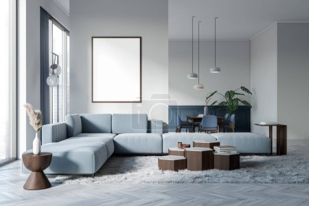 Foto de Interior de la sala de estar azul y blanco con sofá y zona de comedor, lienzo de maqueta en partición. Decoración minimalista y ventana panorámica en rascacielos. Renderizado 3D - Imagen libre de derechos