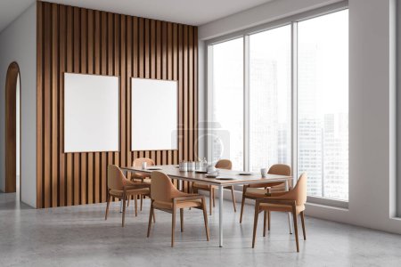 Photo for Modern dining room interior with dinner table and chair, side view grey concrete floor. Panoramic window on skyscrapers. Two blank mockup posters. 3D rendering - Royalty Free Image