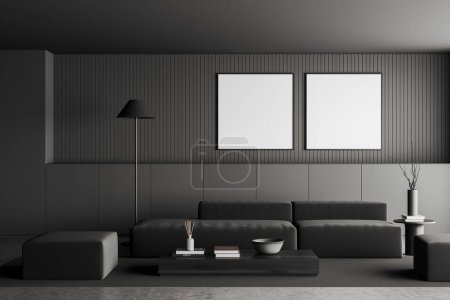 Foto de Dark living room interior with sofa and coffee table with decoration, grey concrete floor. Lounge zone with two square mockup frames in row. 3D rendering - Imagen libre de derechos