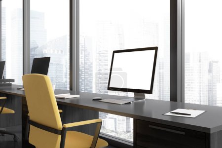 Foto de Workspace interior with pc computer, side view mock up empty screen. Office tools and yellow armchairs, panoramic window on skyscrapers. 3D rendering - Imagen libre de derechos