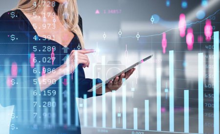 Photo for Businesswoman finger touch tablet in hands. Double exposure with bar chart, forex candlesticks and numbers, office room on background. Concept of online trading - Royalty Free Image