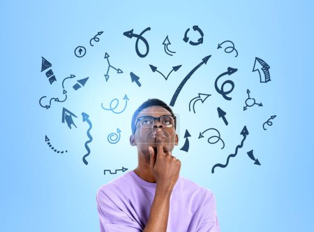 Photo for African young man in purple shirt thinking, finger to mouth. Black arrows doodle on blue background, multiple direction. Concept of options and choice - Royalty Free Image