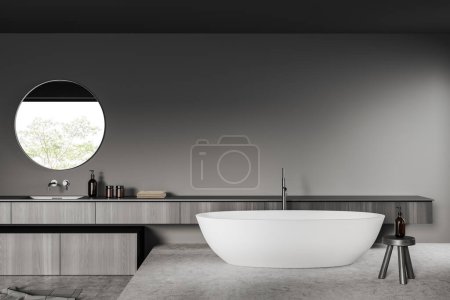 Photo for Dark bathroom interior with bathtub on podium, sink and dresser with accessories, grey concrete floor. Hotel washing area with mockup copy space wall. 3D rendering - Royalty Free Image