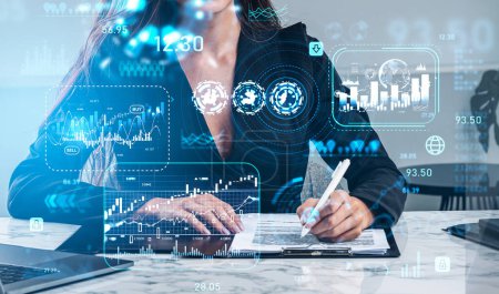 Photo for Businesswoman hand with pen, signing contract, laptop on office table. Stock market changes, forex candlesticks, virtual screen hologram with chart. Concept of finance - Royalty Free Image