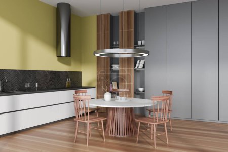 Téléchargez les photos : Colored kitchen interior with dinner table and seats, side view hardwood floor. Modern cooking corner with shelves, hood and shelf with decoration. 3D rendering - en image libre de droit
