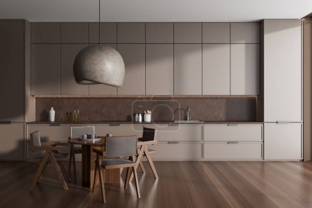 Foto de Modern kitchen interior with dinner table and chairs on hardwood floor. Cooking space with hidden brown shelves and kitchenware. 3D rendering - Imagen libre de derechos