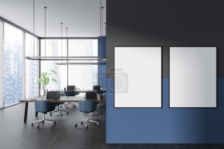 Photo for Dark business interior with laptop on desk, armchairs on grey concrete floor. Panoramic window on skyscrapers. Two mock up canvas posters. 3D rendering - Royalty Free Image