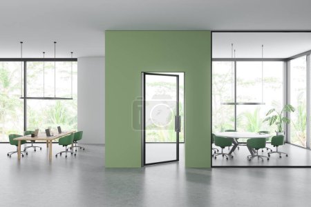 Foto de Side view on bright office room interior with computers, desks, armchairs, panoramic window with countryside view, partition, meeting board, concrete floor. Concept of company, firm. 3d rendering - Imagen libre de derechos