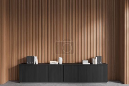 Foto de Front view of stylish dark gray file cabinet with books and folders on it standing in modern office with dark wooden walls and concrete floor. Concept of business interior. 3d rendering - Imagen libre de derechos