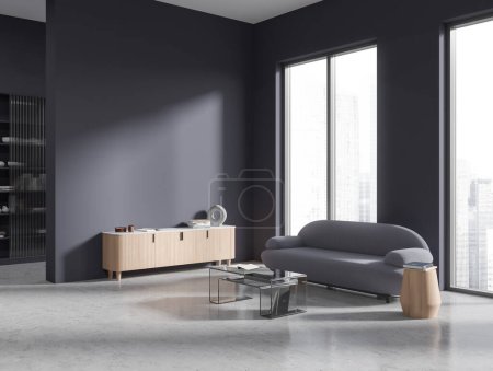 Téléchargez les photos : Corner of modern living room with grey walls, concrete floor, comfortable gray sofa standing between windows with blurry cityscape, glass coffee table and white and wooden cabinet. 3d rendering - en image libre de droit