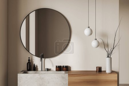 Téléchargez les photos : Intérieur de salle de bain beige avec lavabo et miroir rond, lavabo et accessoires de bain en béton, bouteille de savon et vase avec branche. rendu 3D - en image libre de droit