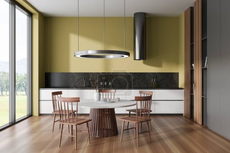 Photo for Interior of stylish kitchen with yellow and gray walls, wooden floor, white cabinets and round dining table with chairs. Panoramic window. 3d rendering - Royalty Free Image