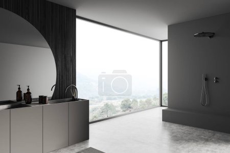 Photo for Dark bathroom interior with shower and sink with mirror, side view, panoramic window on countryside. Deck with bathing accessories, grey concrete floor. 3D rendering - Royalty Free Image
