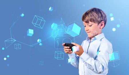 Téléchargez les photos : Portrait de petit garçon sérieux en tenue formelle utilisant un smartphone sur fond bleu avec double exposition d'interface réseau immersive floue. Concept de cyberespace et d'internet - en image libre de droit