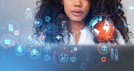 Photo for Unrecognizable young African American woman using laptop with double exposure of blurry immersive medical interface. Concept of digital healthcare - Royalty Free Image
