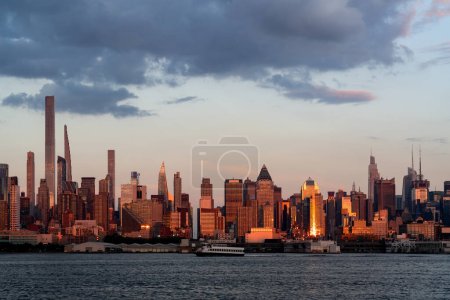 Photo for Cityscape of magnificent Manhattan, New York with skyscrapers and river on sunset. Beautiful west side of NY skyline, the biggest US city. - Royalty Free Image