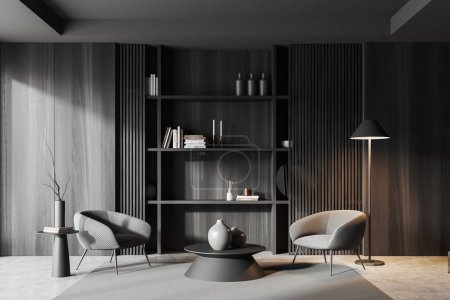 Téléchargez les photos : Salon sombre intérieur avec fauteuils gris et étagère minimaliste avec décoration d'art et livres, tapis sur sol en béton gris. Cozy espace détente dans la maison appartement. rendu 3D - en image libre de droit
