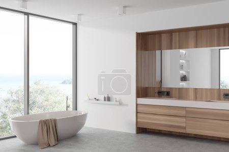 Téléchargez les photos : Hôtel de luxe salle de bain intérieure avec baignoire, double lavabo et commode en bois, vue latérale mock up mur blanc vide. Fenêtre panoramique sur vue mer. rendu 3D - en image libre de droit