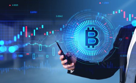 Photo for Businessman hand typing on phone, cryptocurrency hologram with bitcoin and graphs. Binary and numbers with bar chart and lines. Concept of online trading - Royalty Free Image