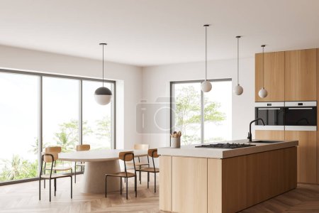 Foto de Moderno interior de cocina blanca con mesa de comedor, vista lateral, sillas y encimera en piso de madera. Zona de comedor con ventana panorámica en los trópicos. Renderizado 3D - Imagen libre de derechos