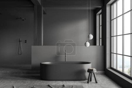 Téléchargez les photos : Intérieur salle de bain sombre avec baignoire et douche avec podium, tabouret avec serviette et cloison. Fenêtre panoramique sur campagne, sol béton gris. rendu 3D - en image libre de droit