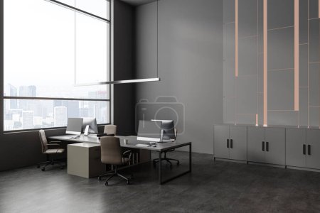 Photo for Dark office interior with armchairs and pc computer on desk, side view grey concrete floor. Coworking corner with sideboard and panoramic window on skyscrapers. 3D rendering - Royalty Free Image