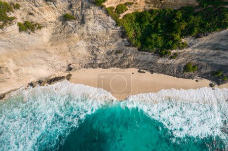 Photo for Aerial drone top view shot of rocky beach with cliff. Indian ocean shore. Copy space for text. Nature and travel background. Beautiful natural summer vacation travel concept. Waves and sand. - Royalty Free Image