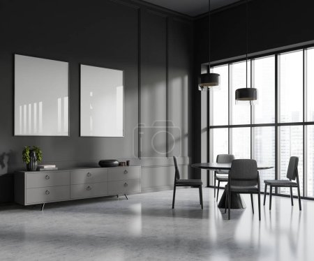 Photo for Interior of stylish dining room with gray walls, concrete floor, round table with chairs and gray dresser with two vertical mock up posters. Window with blurry cityscape. 3d rendering - Royalty Free Image