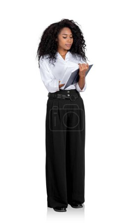 Photo for Black confident businesswoman take note in notebook in hands, full length isolated over white background. Concept of schedule and planning - Royalty Free Image