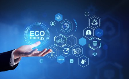 Photo for Businessman hand hold blue glowing eco hud with diverse icons on blue background. Ecosystem and digital technology. Concept of green energy and resources - Royalty Free Image
