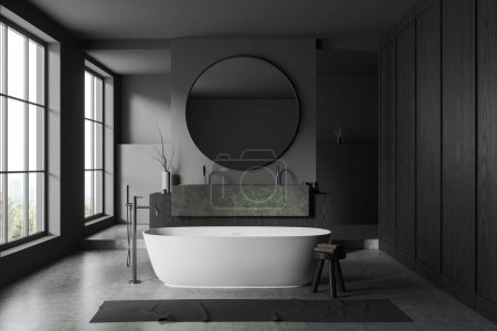 Téléchargez les photos : Intérieur de salle de bain élégante avec des murs en bois gris et foncé, sol en béton, baignoire blanche confortable et double lavabo en pierre avec miroir rond. Rendu 3d - en image libre de droit