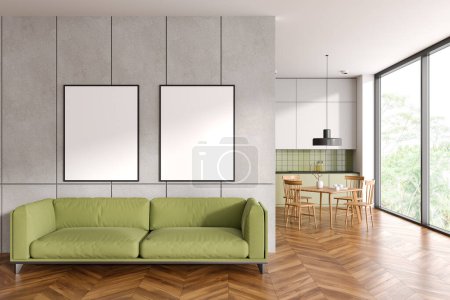Photo for Cozy home studio interior with sofa and kitchen with dinner table on background. Relaxing area with two mock up canvas posters in row. Panoramic window on tropics. 3D rendering - Royalty Free Image