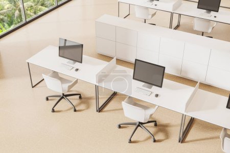 Photo for Top view of office interior with armchairs and pc computer on white desk in row, beige concrete floor. Coworking corner with sideboard and panoramic window. 3D rendering - Royalty Free Image