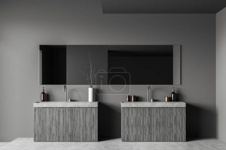 Photo for Dark bathroom interior with double sink and large mirror, deck with hotel bathing accessories, grey concrete floor. 3D rendering - Royalty Free Image