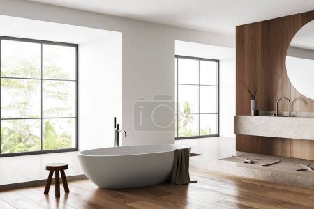 Téléchargez les photos : Intérieur de salle de bain blanche avec baignoire, vue latérale, lavabo et miroir et décoration d'hôtel, sol en béton beige. Fenêtre panoramique sur les tropiques. rendu 3D - en image libre de droit