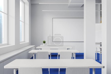 Photo for Interior of modern classroom with white walls, blue floor, row of white tables with chairs, windows and mock up whiteboard. 3d rendering - Royalty Free Image