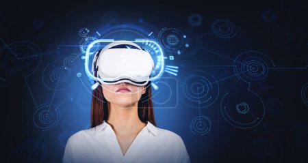 Photo for Portrait of young woman wearing VR glasses over dark blue background with double exposure of immersive network interface. Concept of metaverse - Royalty Free Image